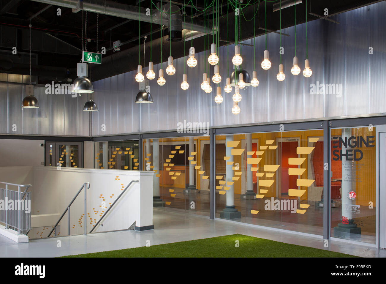 Engine Shed is a collaboration between Bristol City Council, the University of Bristol and the West of England Local Enterprise Partnership at the heart of Temple Quarter Enterprise Zone. Interior view of the building. Contemporary architecture and design. Hanging ceiling lights. Stock Photo