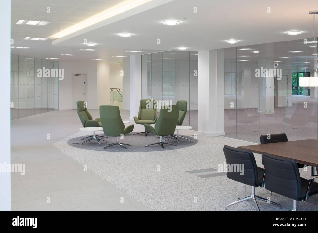 The Capitol Building, Bracknell. Interior view of a modern office area in The Capitol Building with office chairs and tables. Glass wall and sky lights. Stock Photo