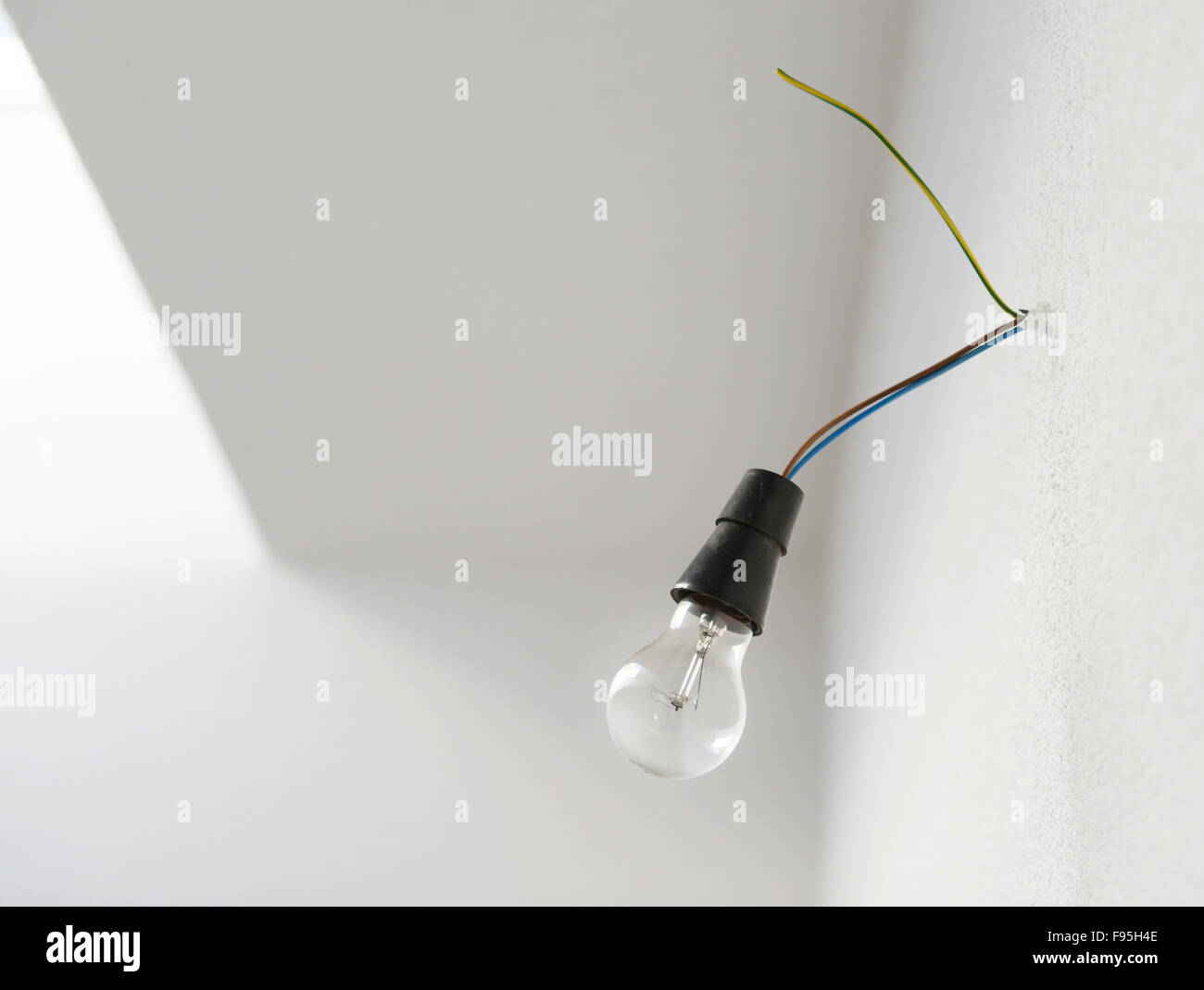 Hanging transparent glass bulb from unfinished construction Stock Photo ...