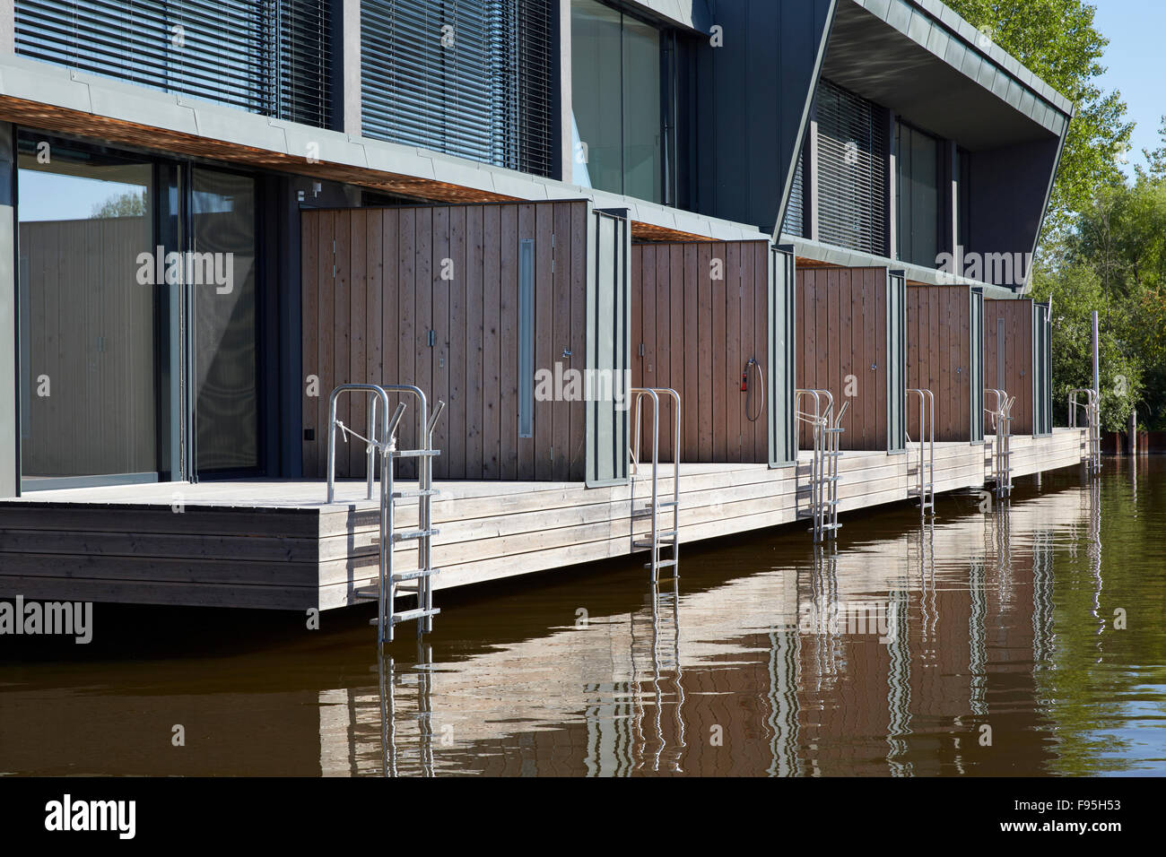 Housing development at Lake Neusiedl, Neusiedl am See, Burgenland, Austria. Exterior view of six terraced units with decking and ladder access to the lake at the contemporary waterside housing development at Neusiedl am See, Burgenland, Austria. Stock Photo