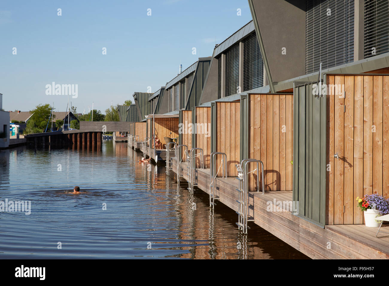 Housing development at Lake Neusiedl, Neusiedl am See, Burgenland, Austria. Swimming in the lake at the contemporary housing development at Neusiedl am See, Burgenland, Austria. Stock Photo