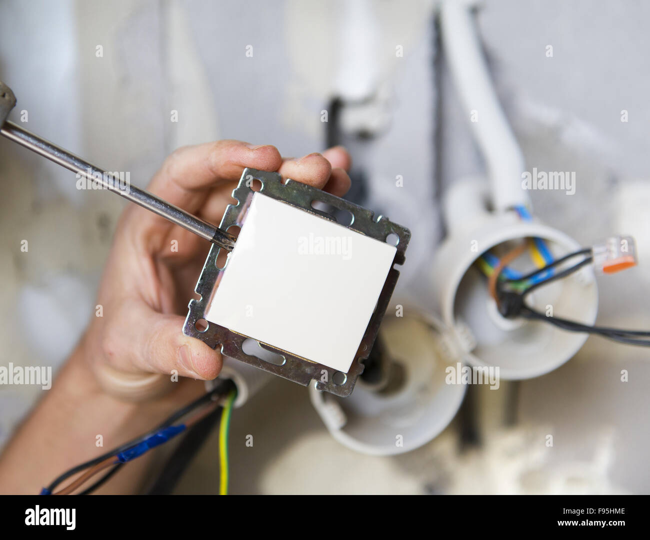 Electrician installing light in a new house Stock Photo Alamy
