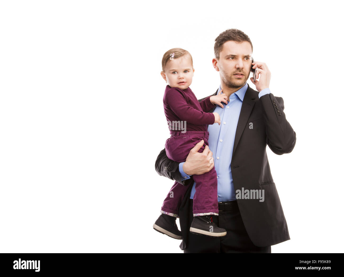 Man with his baby is working. Manager is using mobile phone. Stock Photo