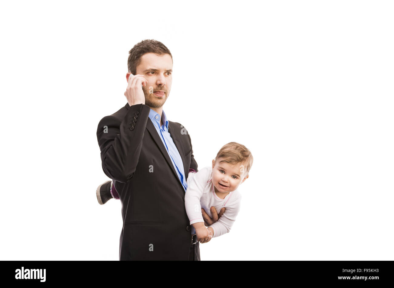 Man with his baby is working. Manager is using mobile phone. Stock Photo