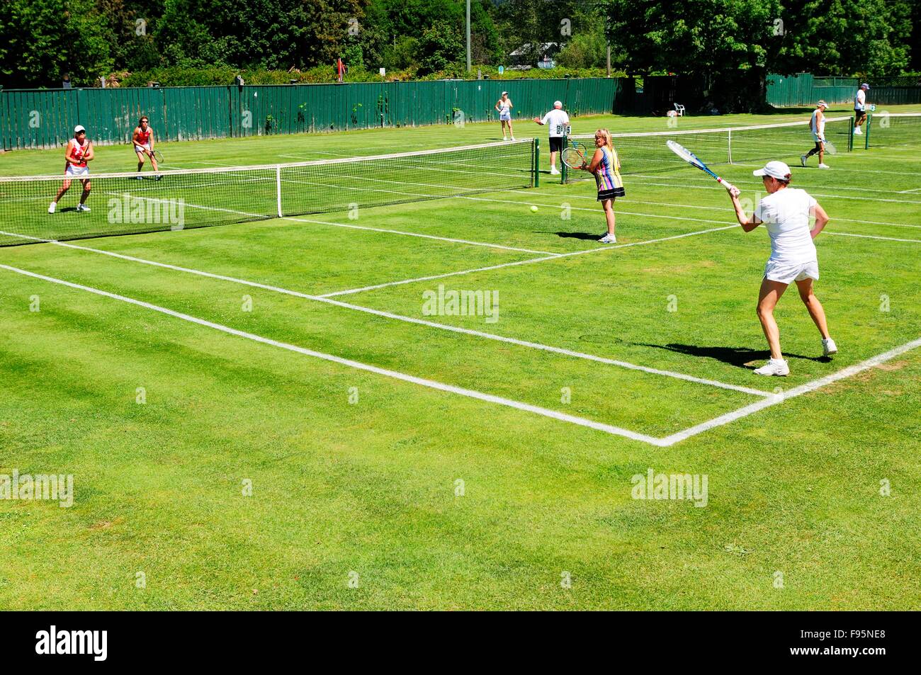 Women's doubles action during the 126th Vancouver Island Grass Court Championships at the South Cowichan Lawn Tennis Club in Stock Photo