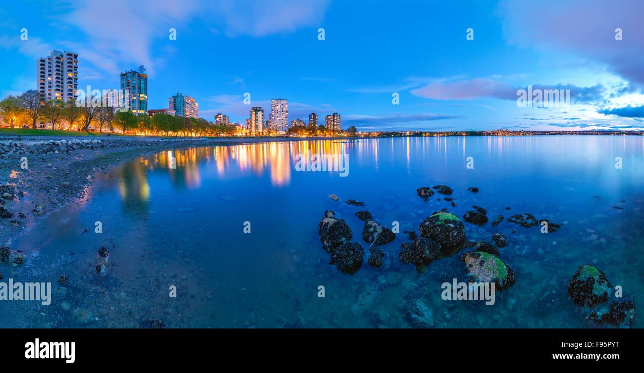 Looking toward Vancouver and Beach Avenue from English Bay at low tide at twilight. Stock Photo