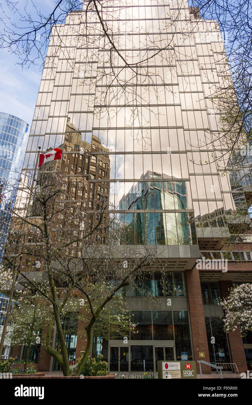 HSBC Building downtown Vancouver BC. The Marine buiding reflection in the gold coloured glass. Stock Photo