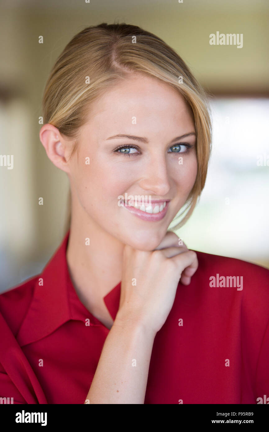 Portrait of young blond woman in red blouse Stock Photo