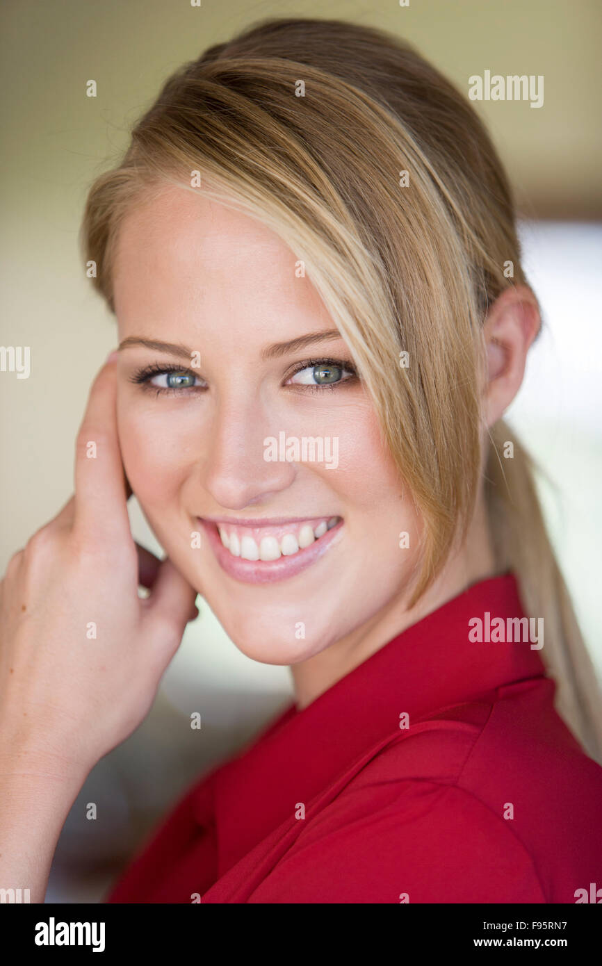 Portrait of young blond woman in red blouse Stock Photo