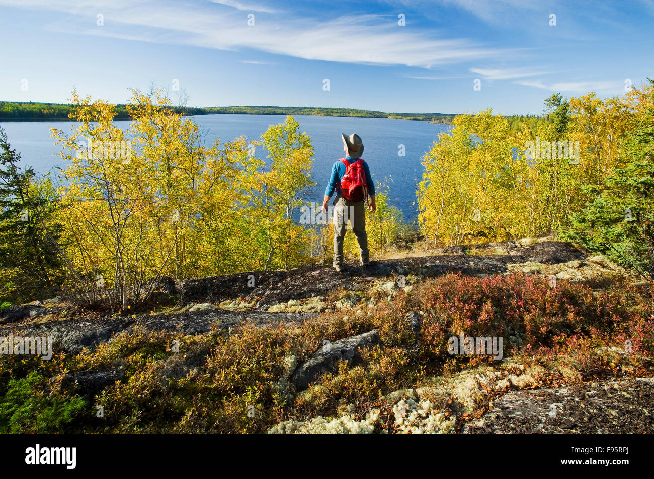 hiker looking out over Devil Lake, Northern Saskatchewan, Canada Stock Photo