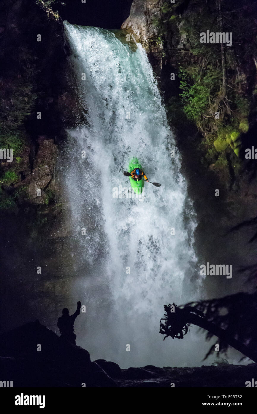 Whitewater kayaker going over sutherland falls, Revelstoke, British