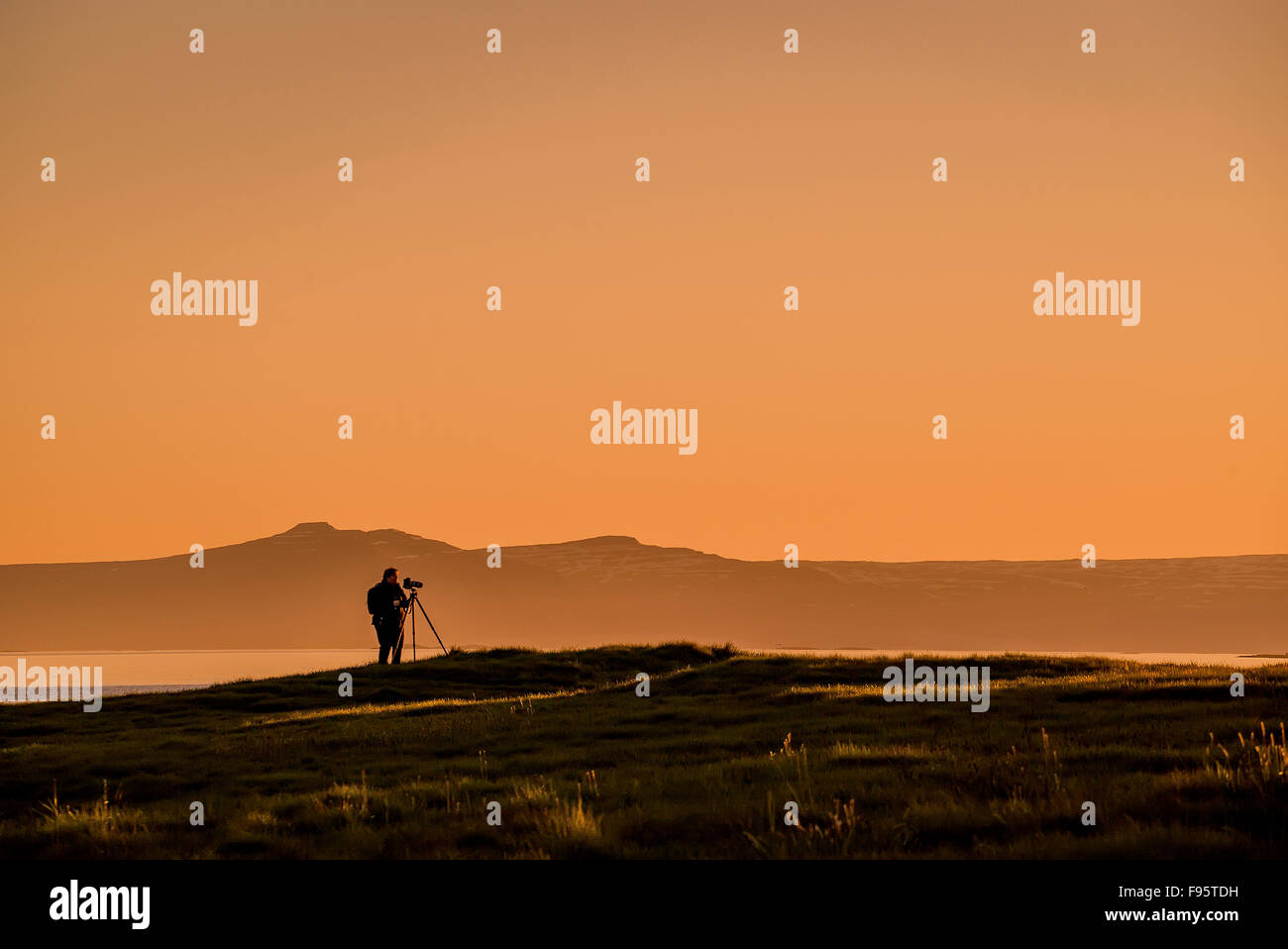Photographer at sunset, Flatey Island, Breidafjordur, Iceland Stock Photo