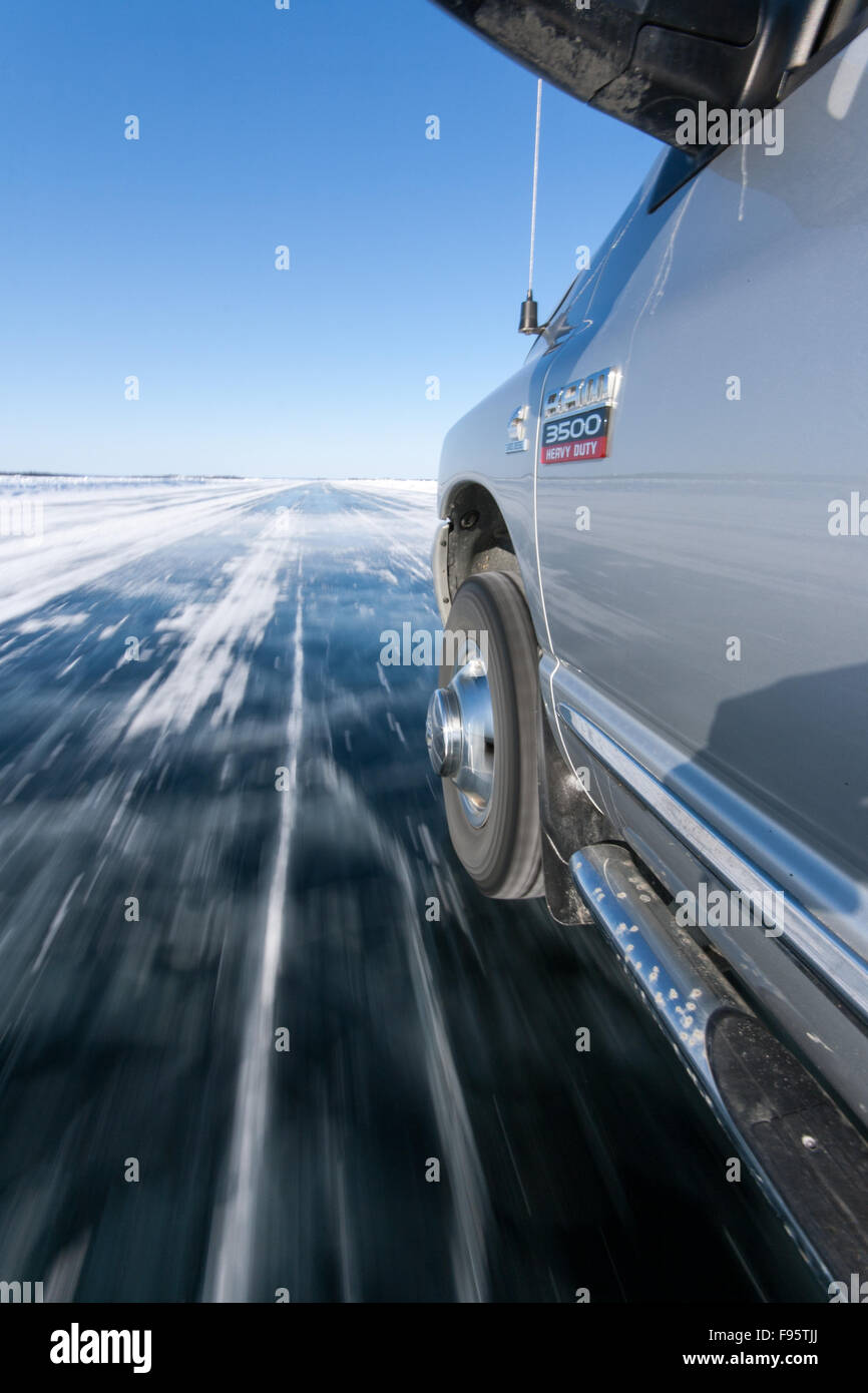A truck drives on an ice road in the Northwest Territories, Canada. Stock Photo