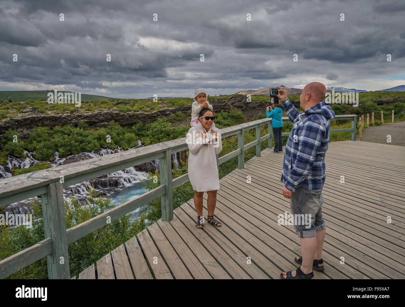 Taking family pictures at Hraunfossar, Borgarfjordur, Iceland Stock Photo