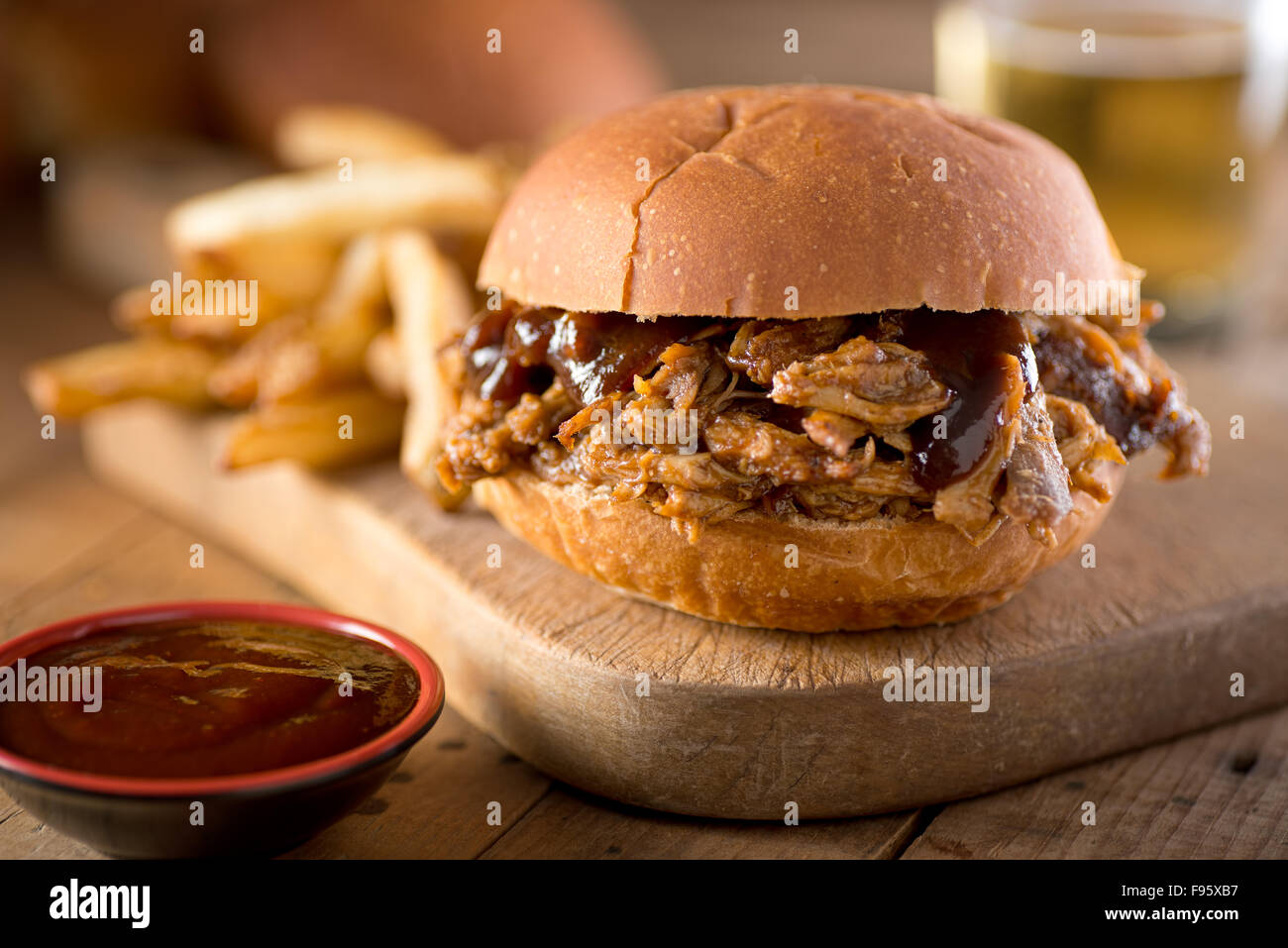 A delicious pulled pork sandwich with barbecue sauce on a bun. Stock Photo