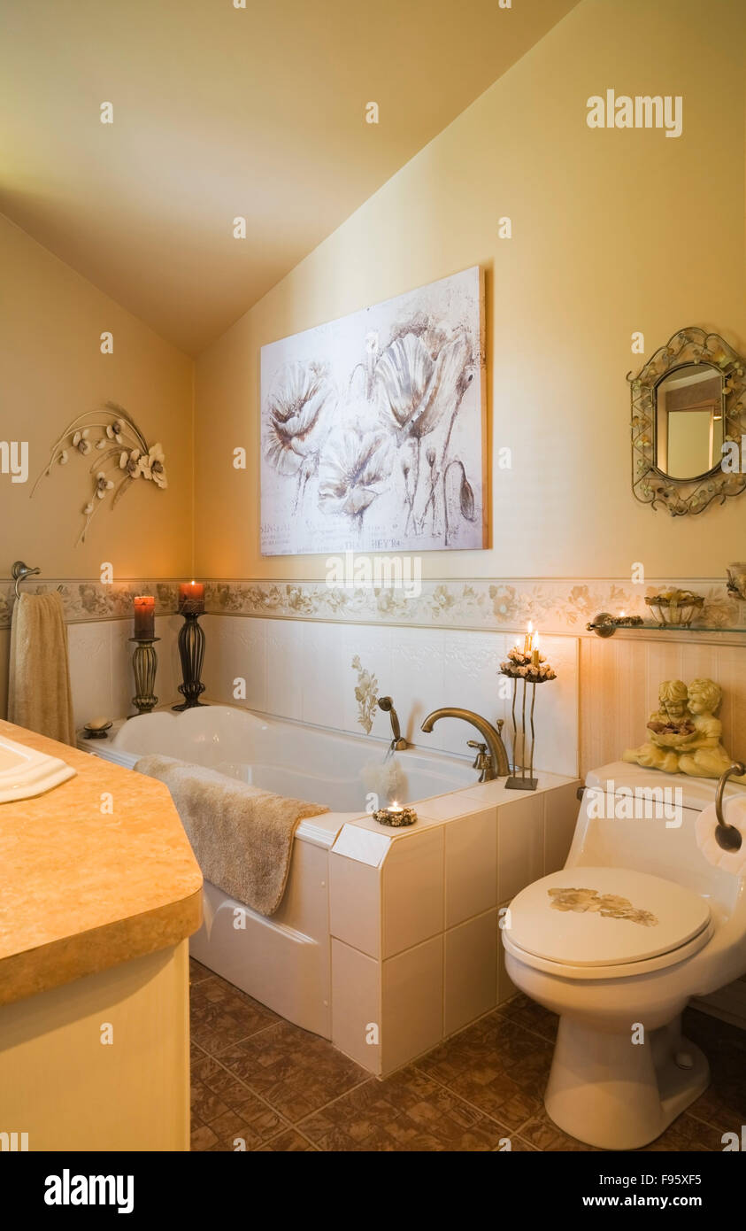 Ensuite bathroom with  laminated countertop and ceramic tile flooring inside a Archimed style residential home, Quebec, Canada. Stock Photo