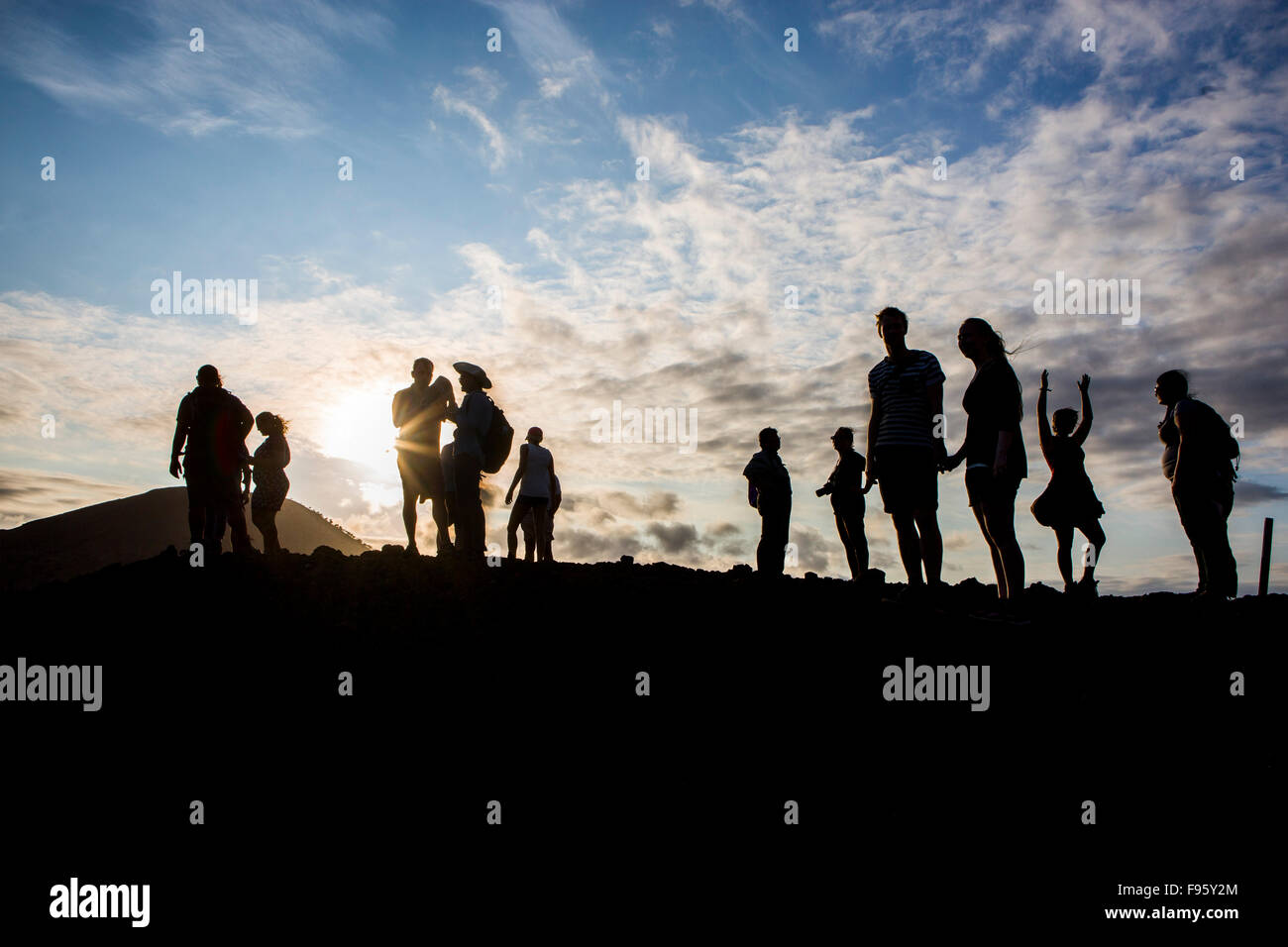 The Galapagos Islands , Ecuador . Tourists enjoy the sunset Stock Photo