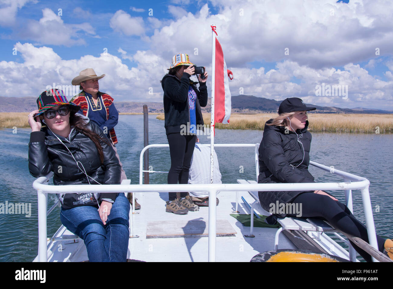 Visitors aboard tour boat, Lake Titicaca, Peru Stock Photo