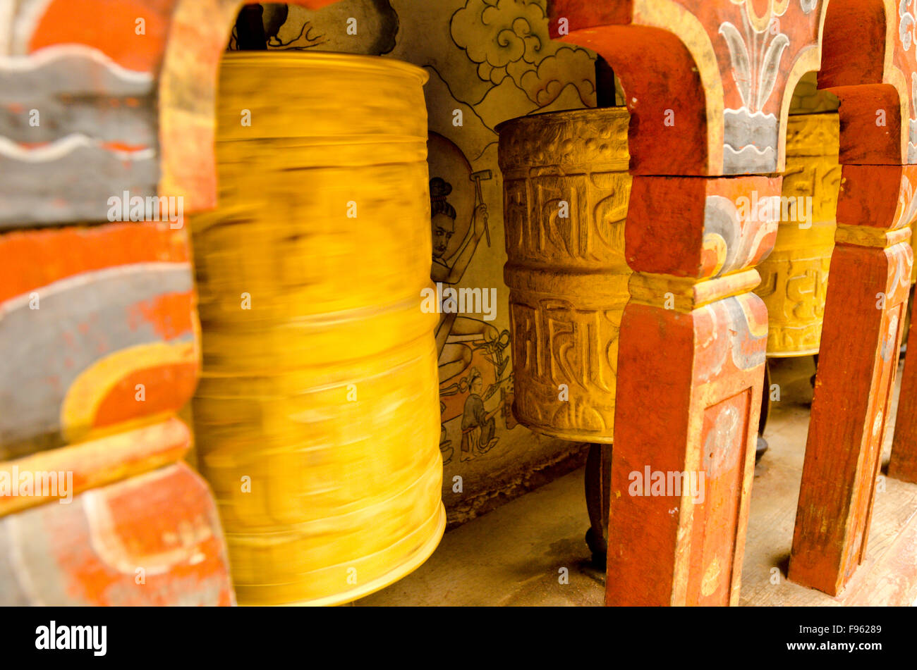 Prayer wheels at a temple portray various gods and deities, Bhutan Stock Photo