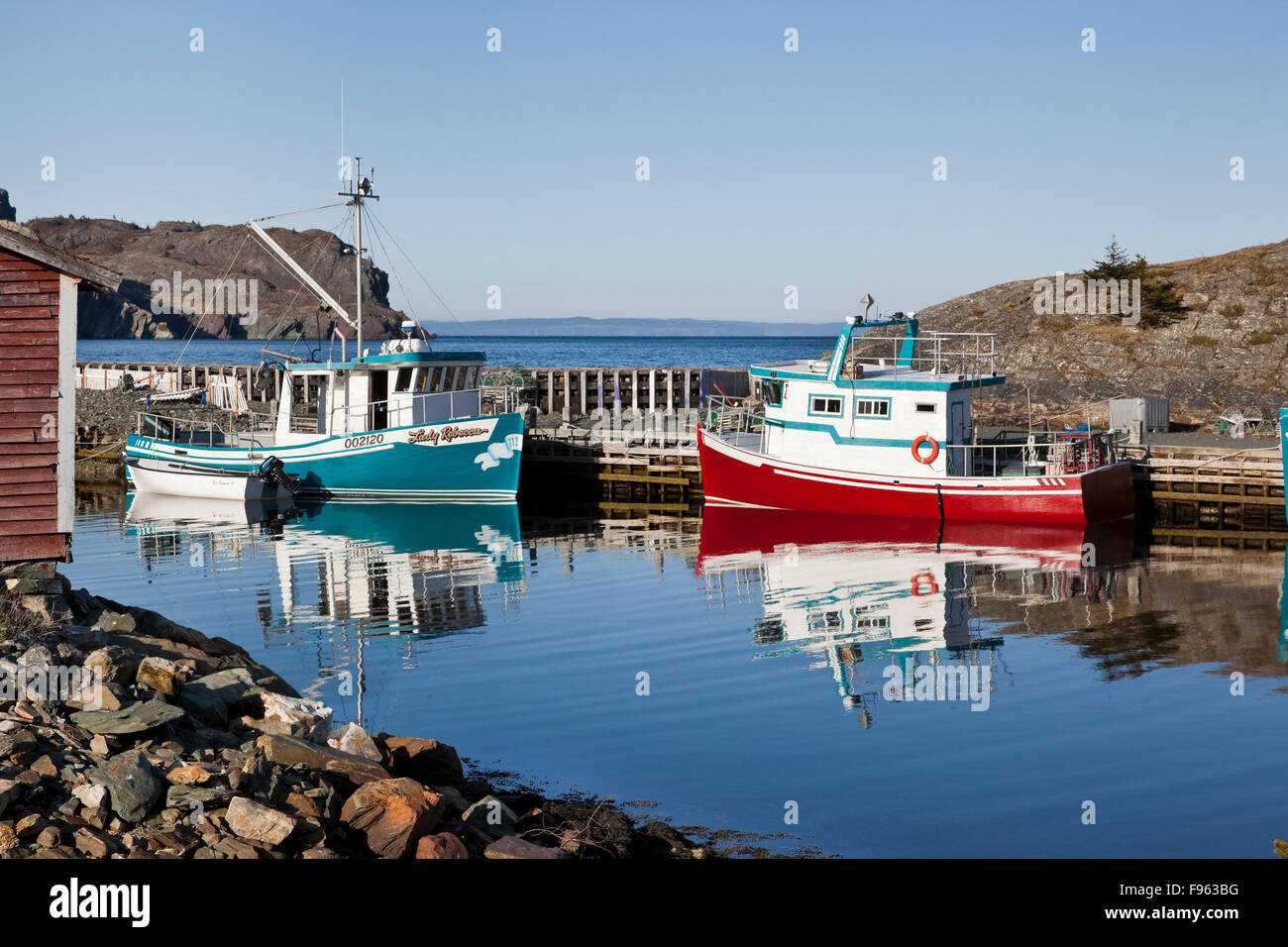 Two Cape Islander fishing boats moored in small harbour in Brigus, Newfoundland Stock Photo