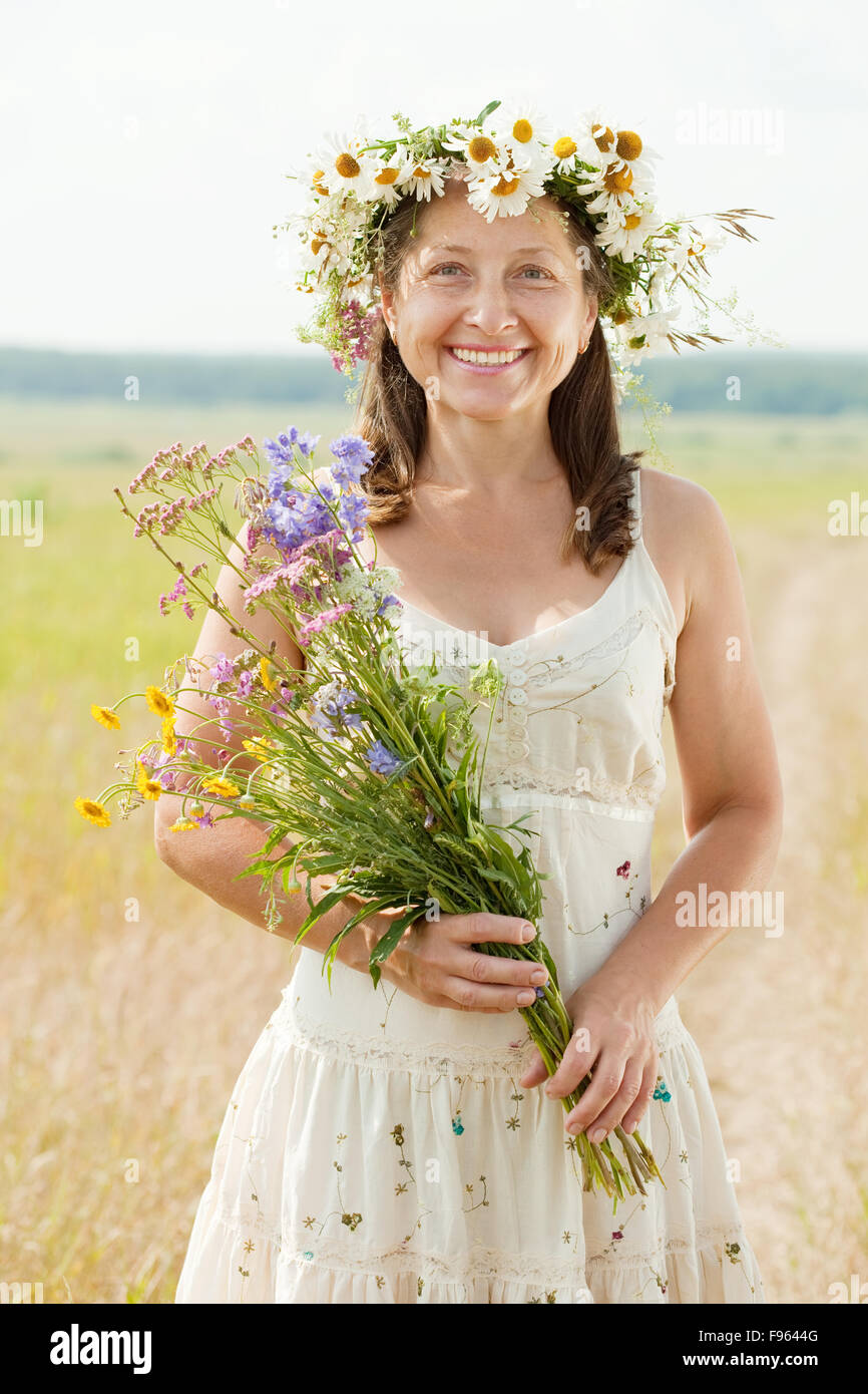 happy mature woman in summer field Stock Photo - Alamy
