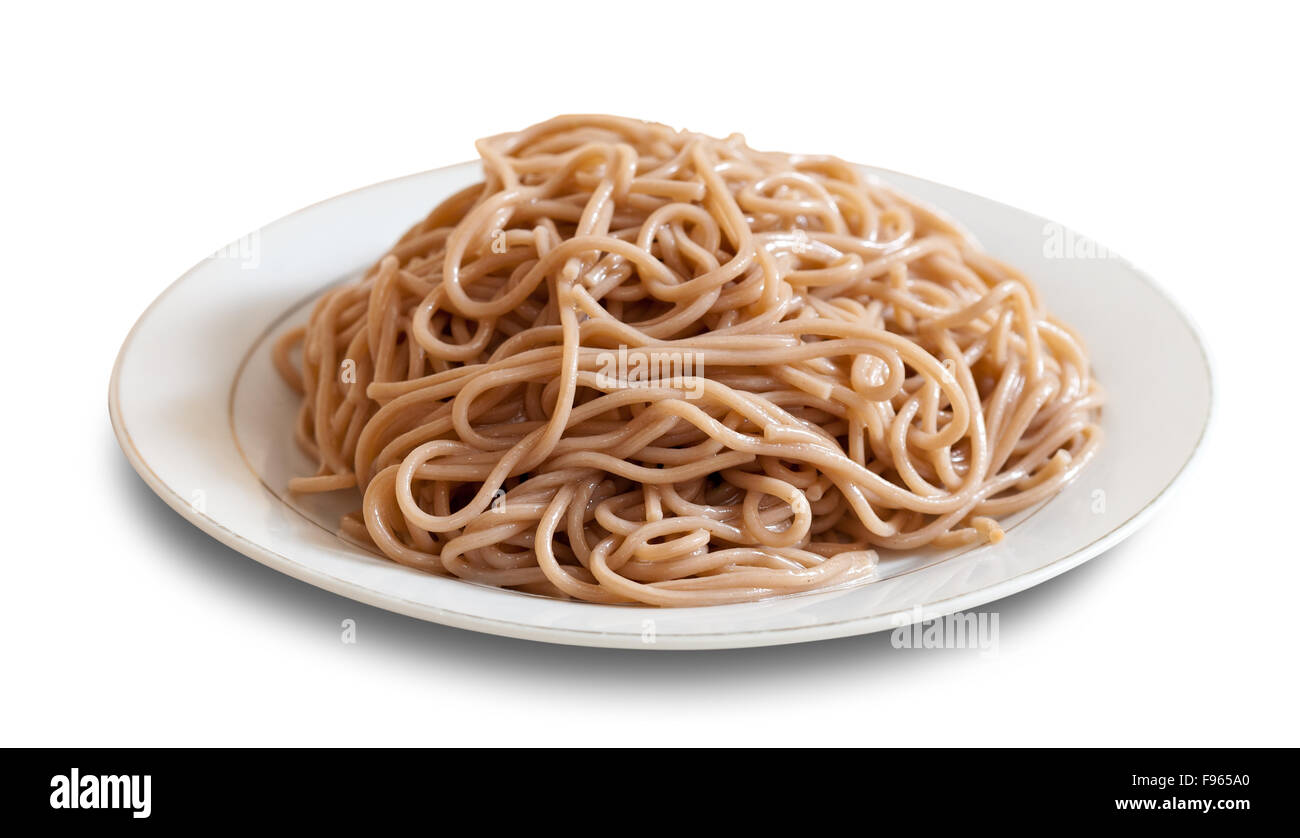 Buckwheat spaghetti pasta  in plate over white background with shade Stock Photo