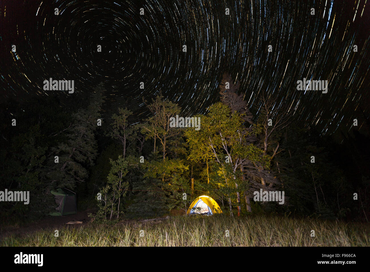 Star trails over a Lake Superior campsite in Lake Superior Provincial Park, Ontario, Canada (image stacking) Stock Photo
