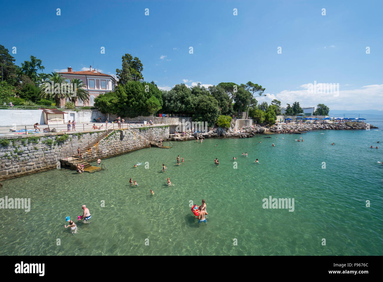 Tourists swimming on the coastline in Opatija, Croatia Stock Photo