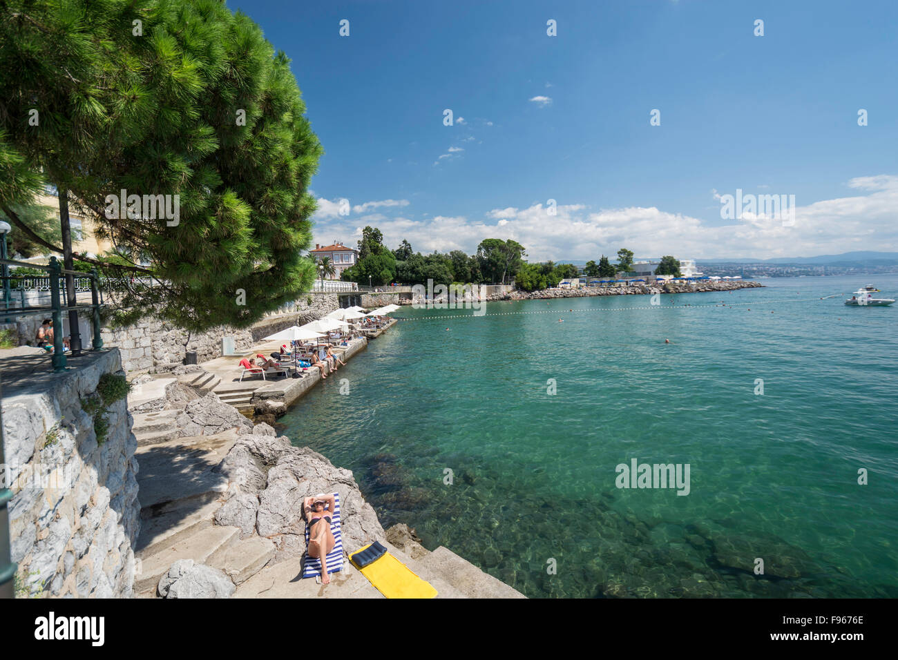Tourists relaxing on the shoreline in Opatija, Croatia Stock Photo
