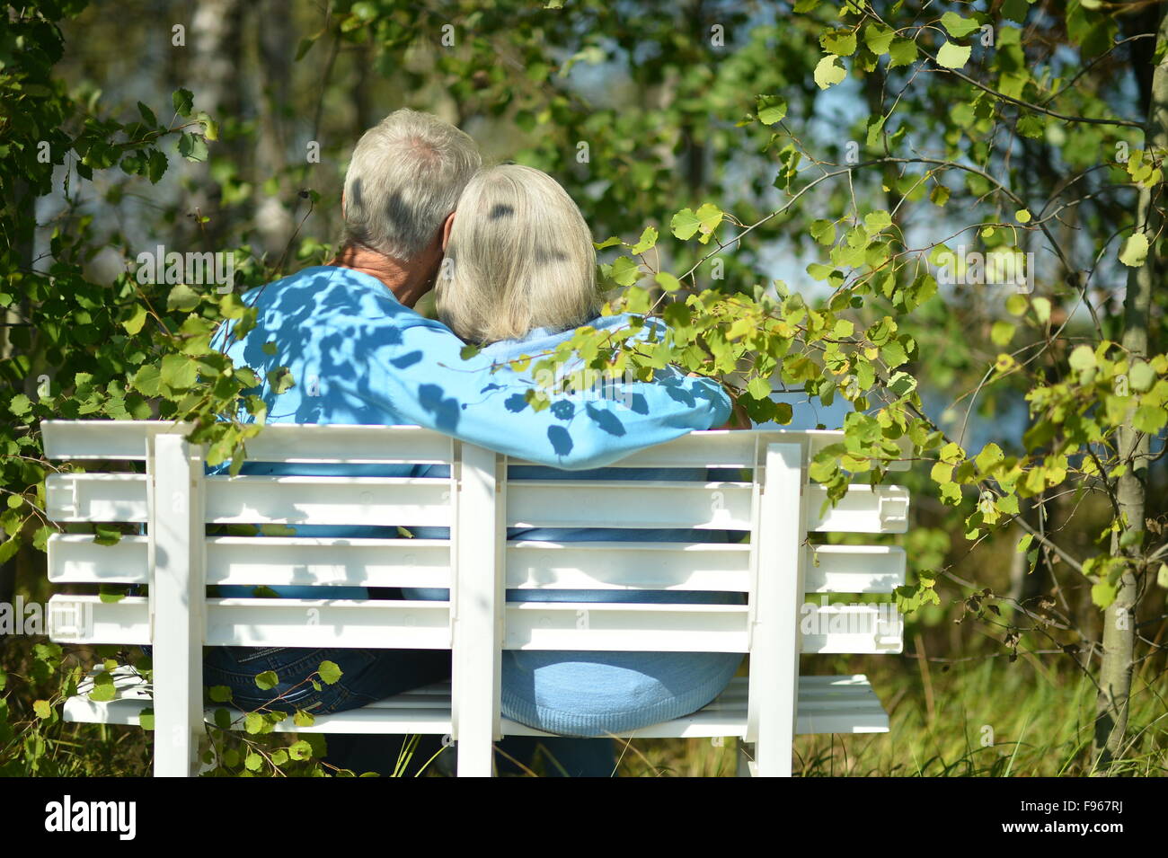 senior couple sitting on bench Stock Photo - Alamy