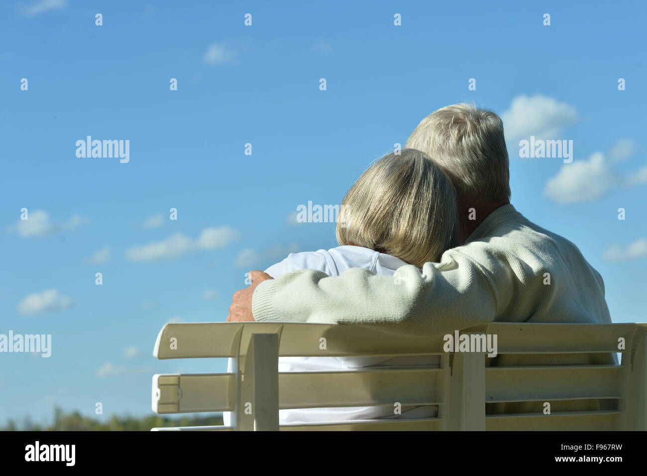 senior couple sitting on bench Stock Photo - Alamy