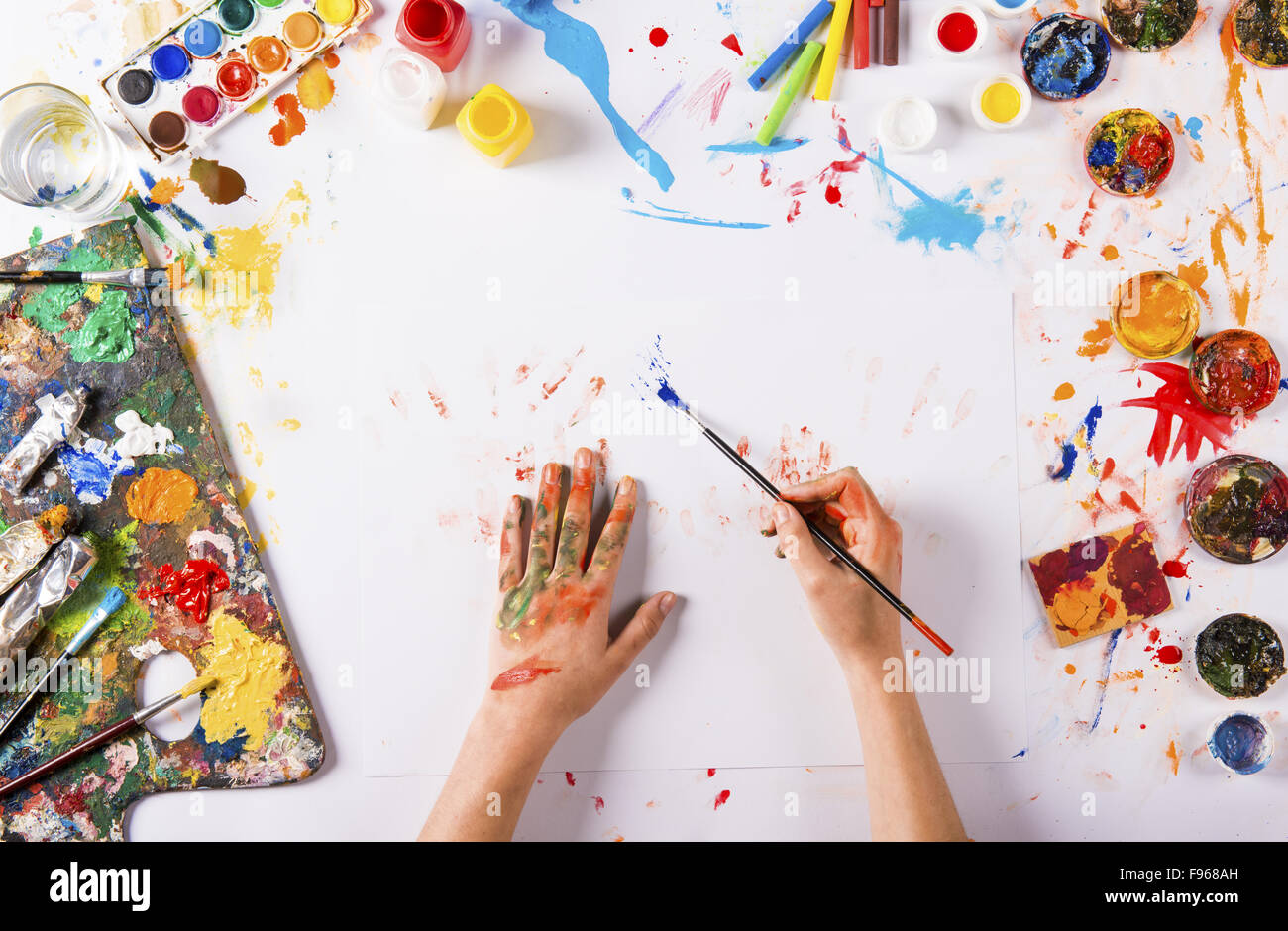 Creative art concept with colorful paints over white paper Stock Photo ...