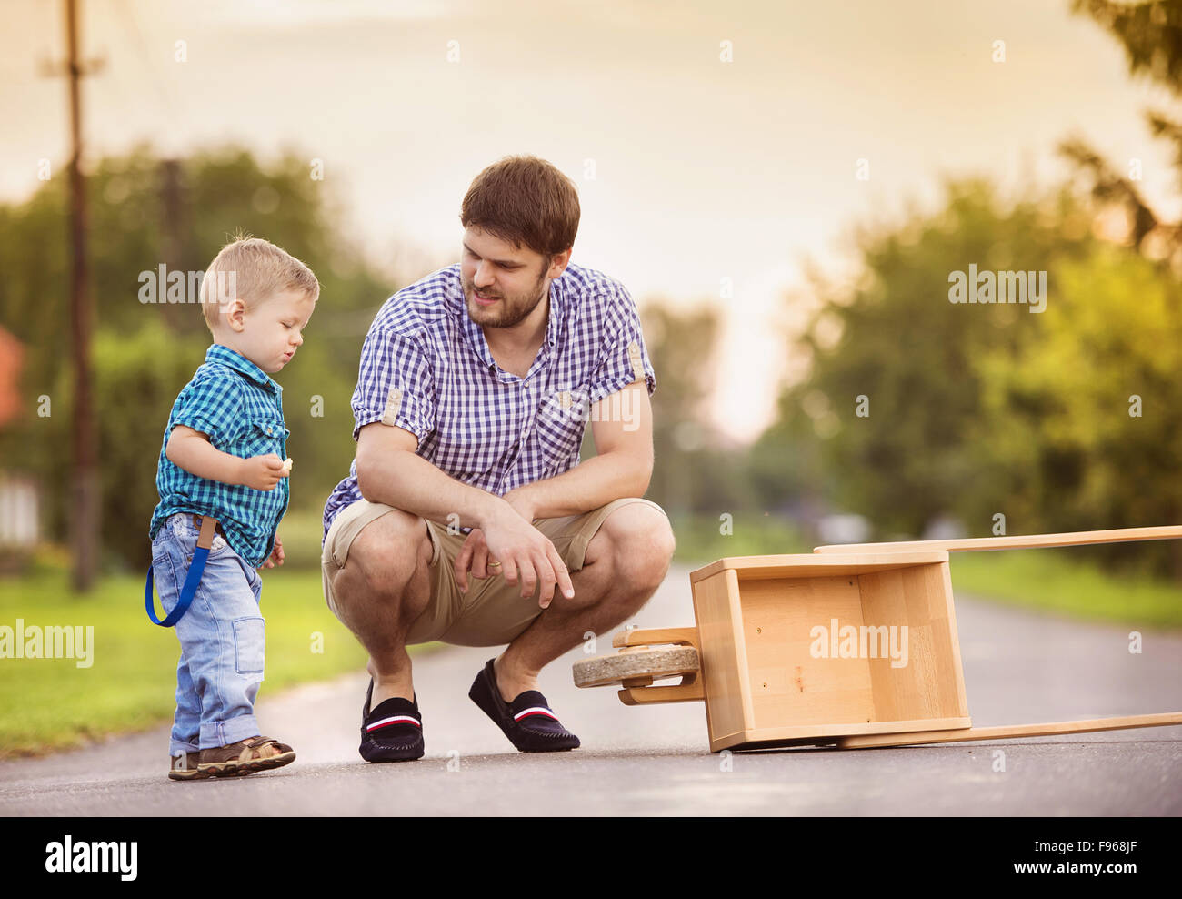 Young father talking with his little son on street Stock Photo