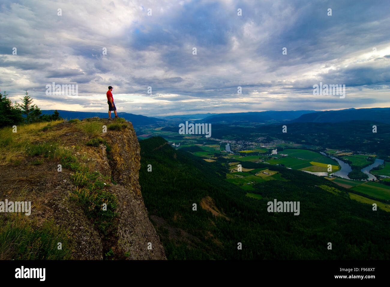 Hiker revels in the view after a challenging, yet rewarding hike to the top of the Enderby Cliffs, overlooking Enderby, in the Stock Photo