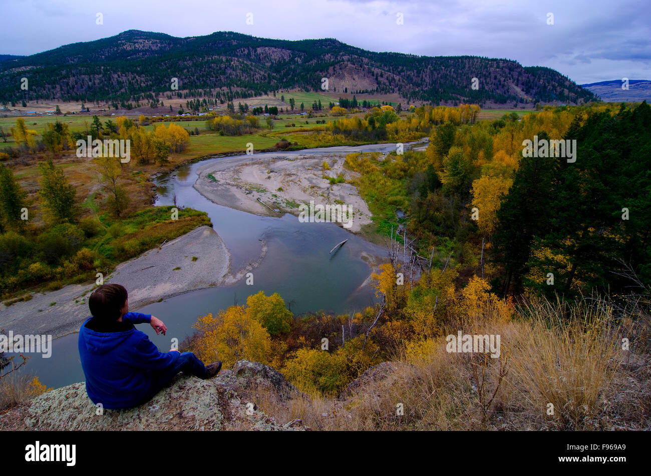 Hiker savours the autumn view of the Nicola River, near Merritt, British Columbia, Canada Stock Photo