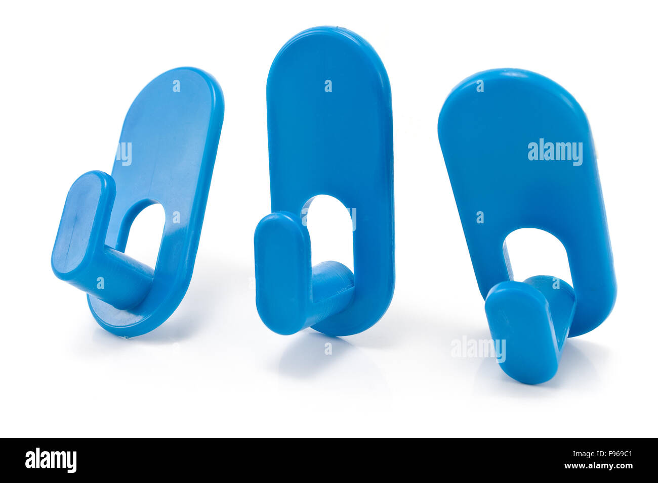 Three blue plastic wall hook hangers isolated on white Stock Photo
