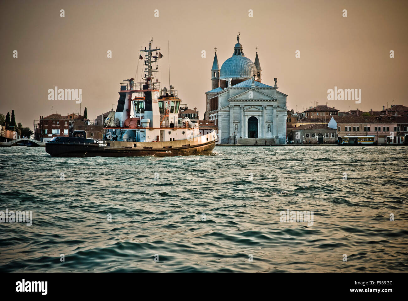 tugboat passing Il Redentore church Stock Photo