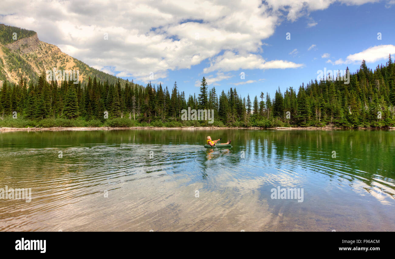 Man Paddling in a Rubber Boat on Bertha Lake in Waterton Lakes National