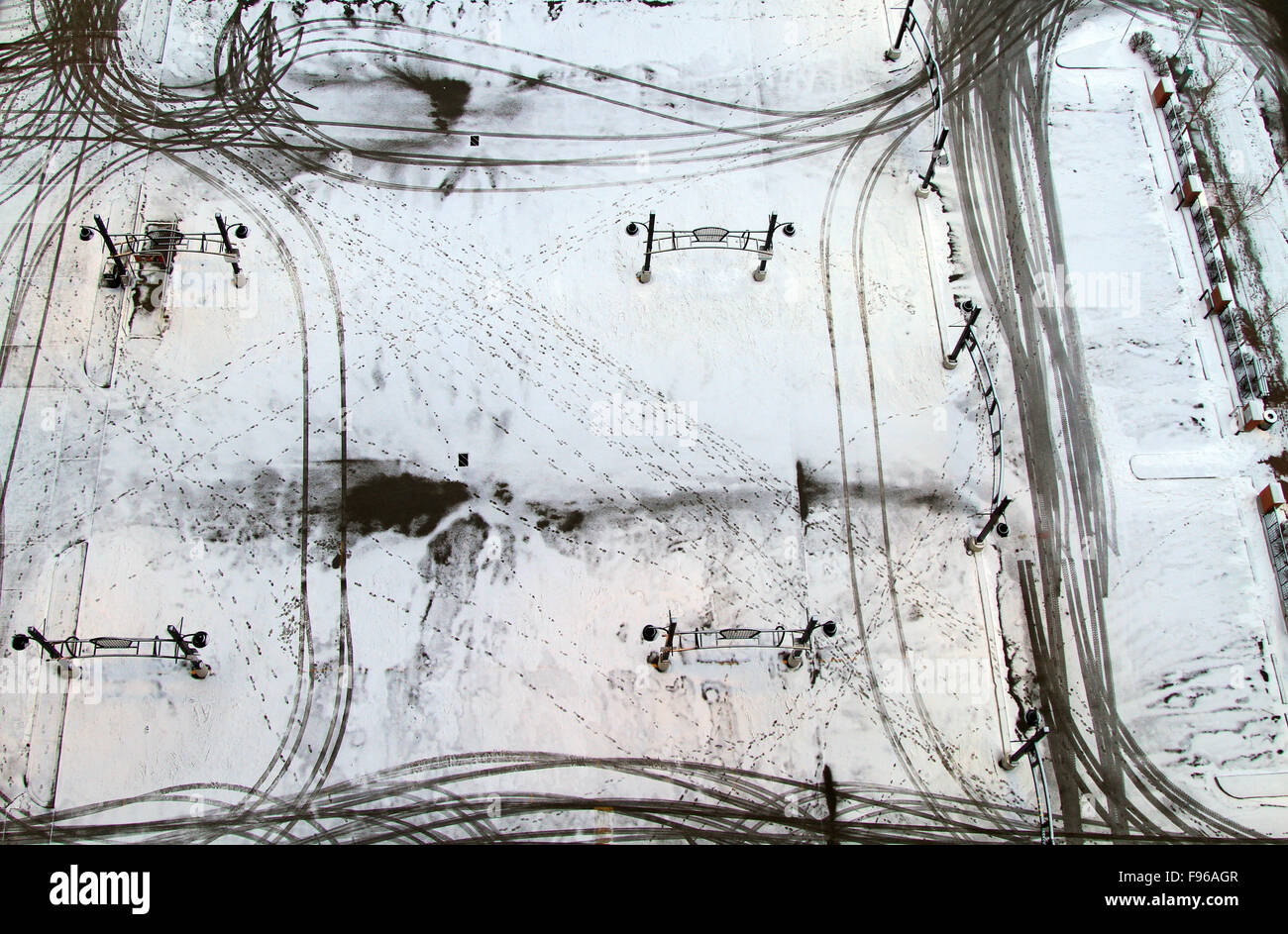 Footsteps and Car Tracks in a Snowy Parking Lot in Downtown Calgary