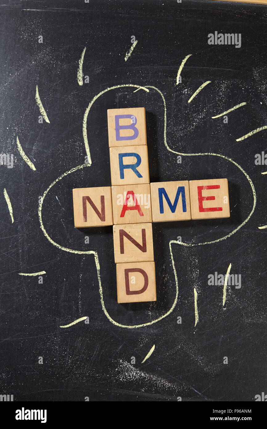 Brand Name Crossword with wooden block on the blackboard Stock Photo