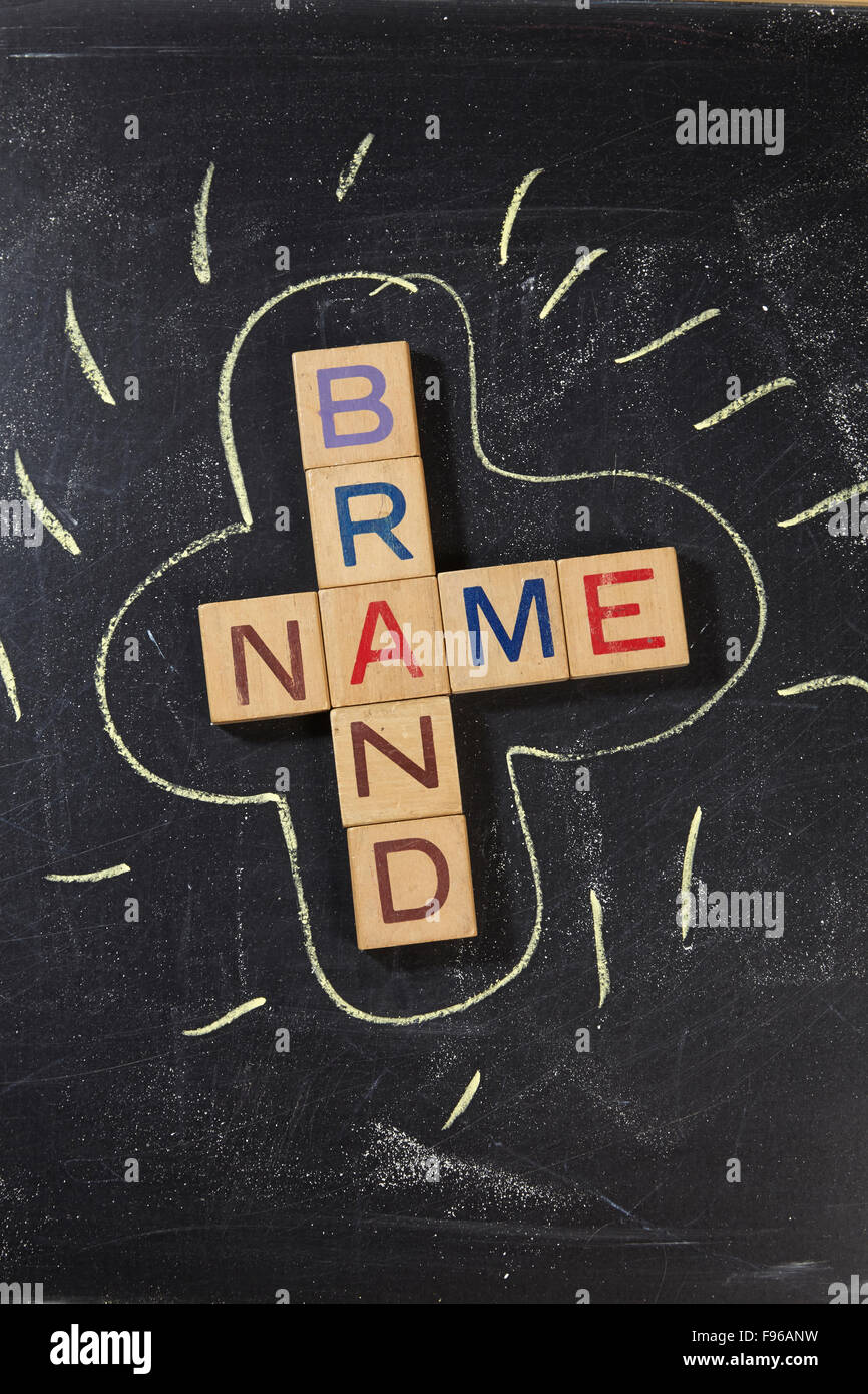 Brand Name Crossword with wooden block on the blackboard Stock Photo