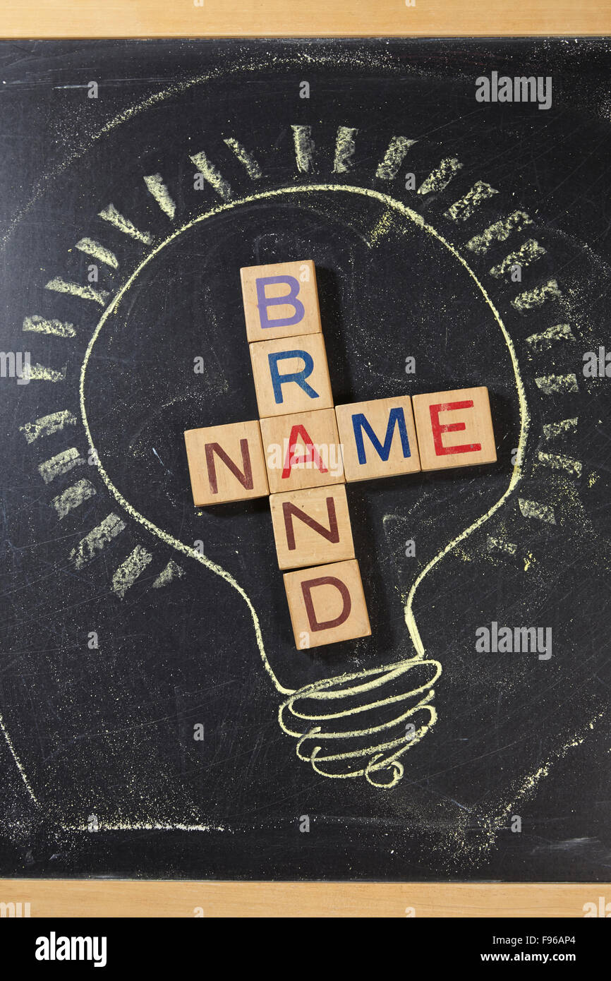 Brand Name Crossword with wooden block on the blackboard Stock Photo