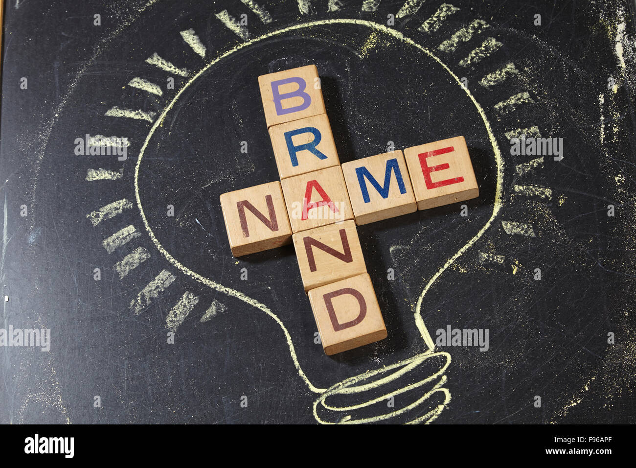 Brand Name Crossword with wooden block on the blackboard Stock Photo