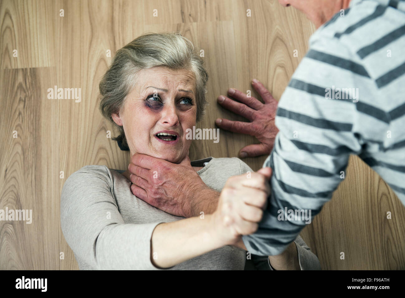 Woman victim of domestic violence and abuse. Mature woman with black eye  scared of a man with a belt Stock Photo - Alamy