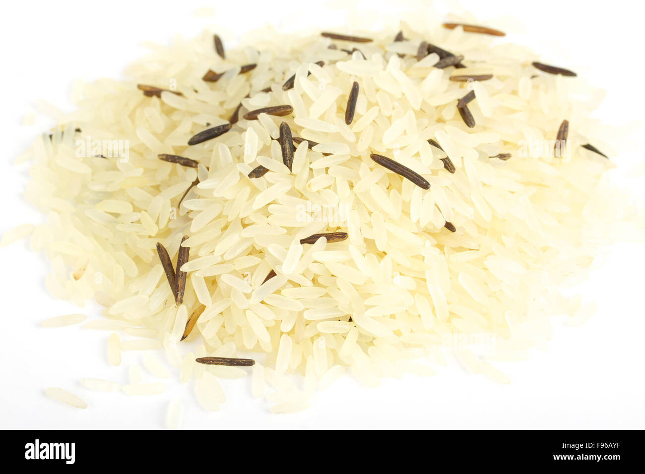 Closeup of long rice mixed with wild rice isolated on white background ...