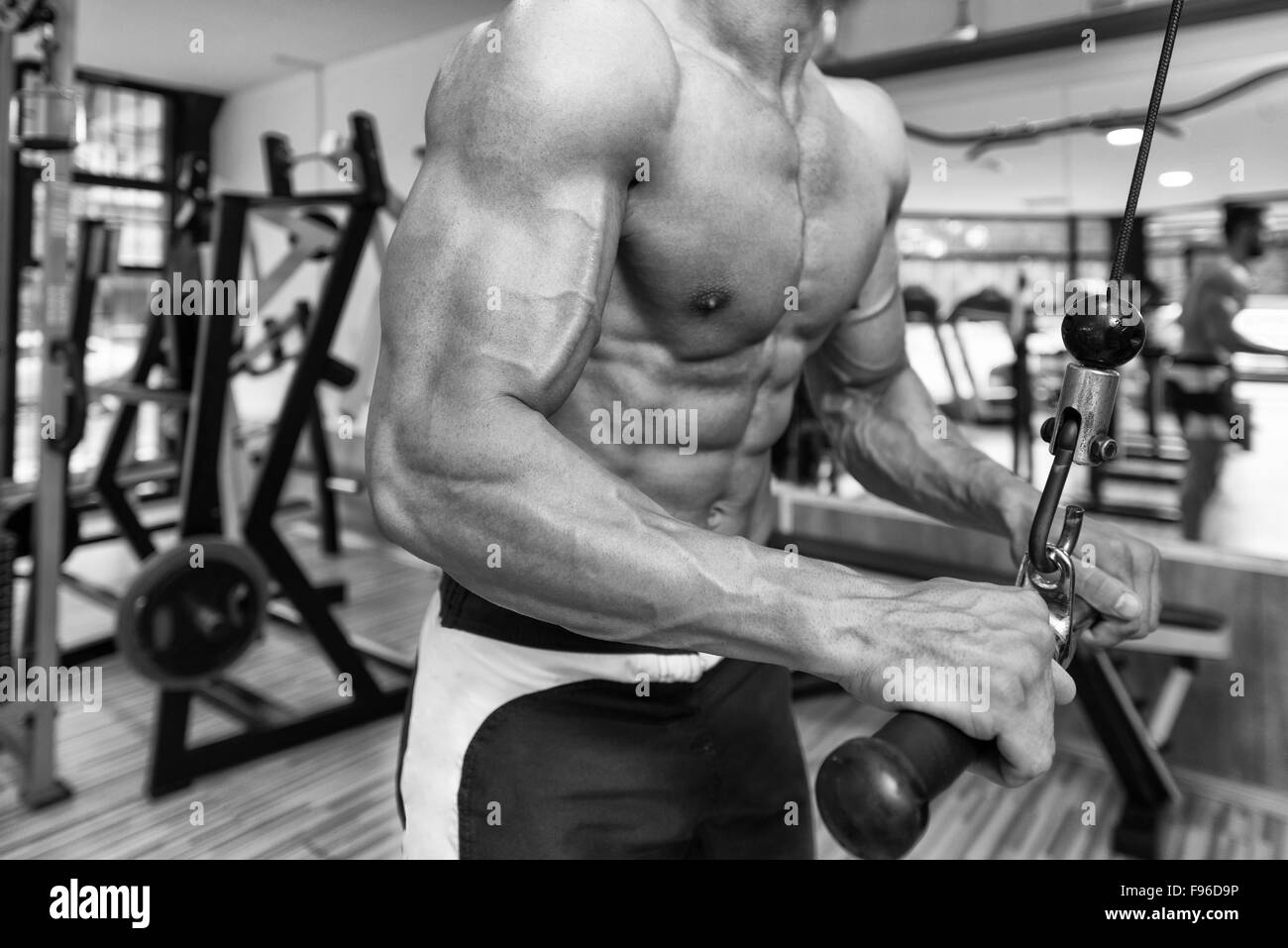 Young Bodybuilder Exercise Triceps In The Gym - He Is Performing Two Arm  Triceps Push Downs Stock Photo - Alamy