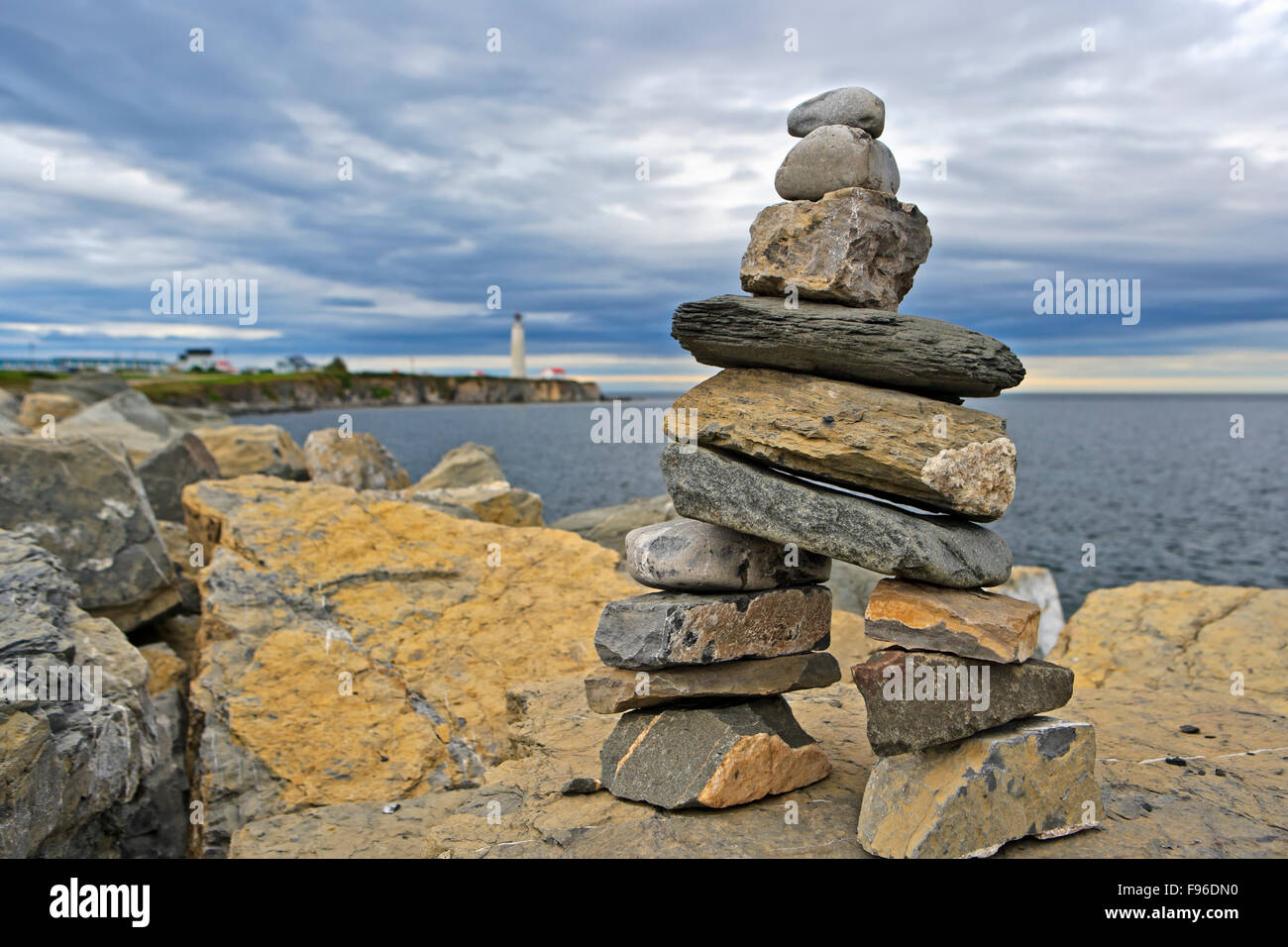 Stone figure with CapdesRosiers Lighthouse in the background, Land's End, Gaspesie, Gaspesie Peninsula, Highway 132, Quebec, Stock Photo