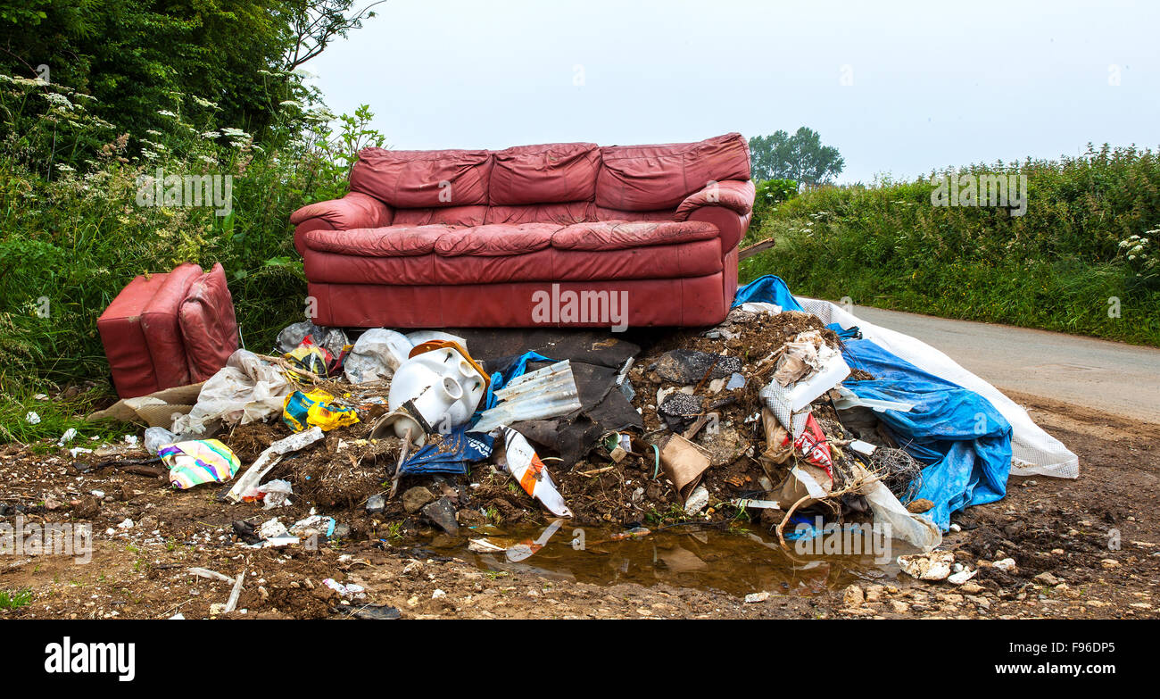 Waste dumped in the Wiltshire countryside, an illegal social issue, fly tipping causing environmental pollution Stock Photo
