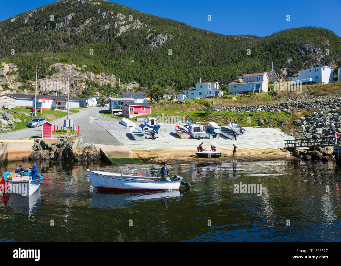 Fishermen unloading dories, Bauline Harbour, Newfoundland, Canada Stock Photo
