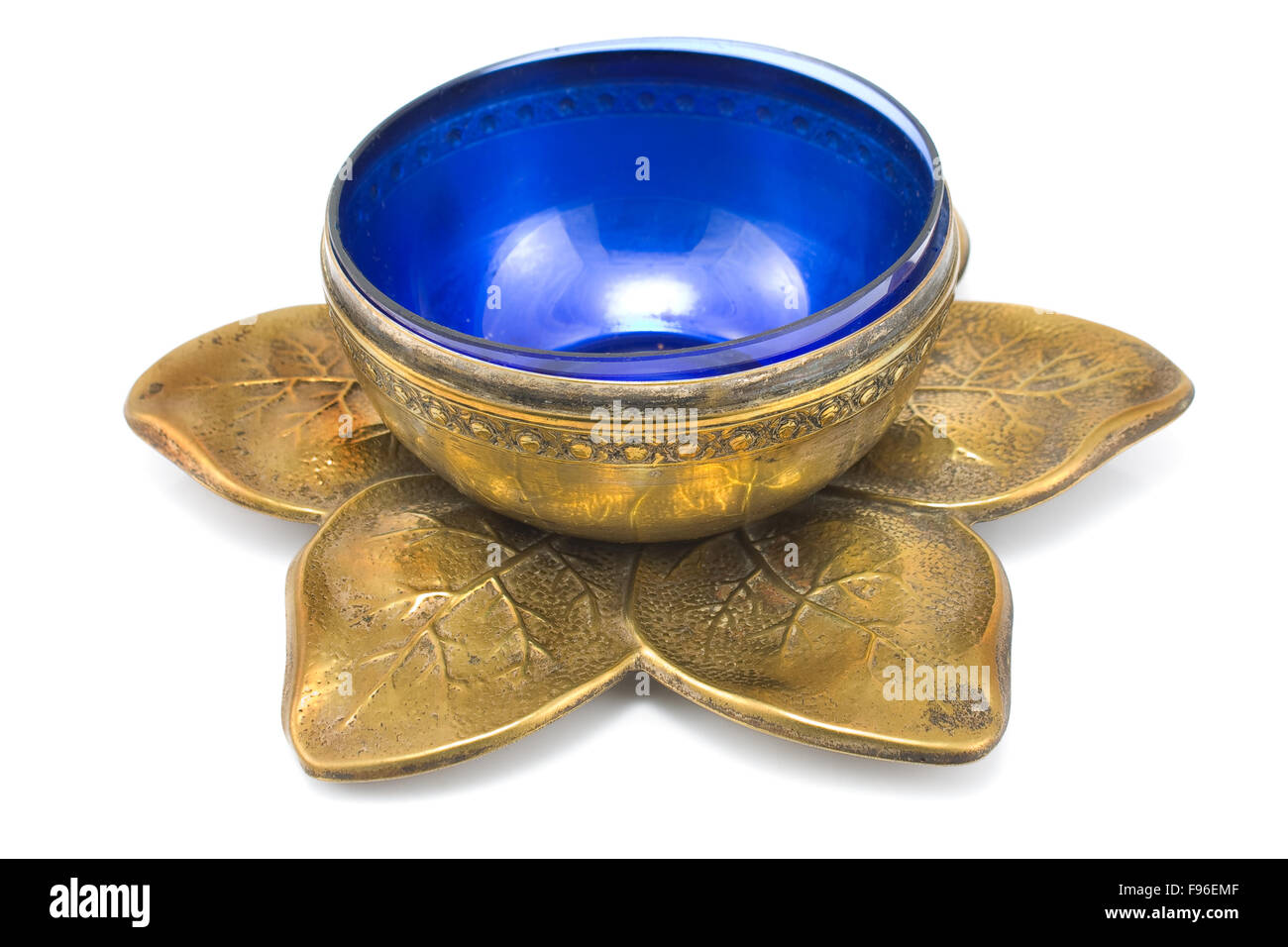 Antique brass pot with blue glass isolated on white Stock Photo